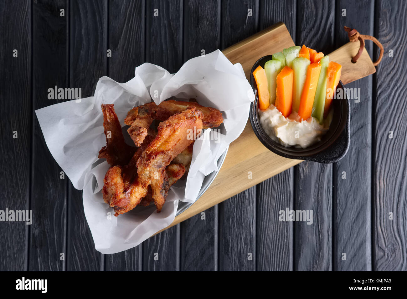 Snack for beer. Spicy chicken wings with fresh carrot and celery and sauce Stock Photo Alamy