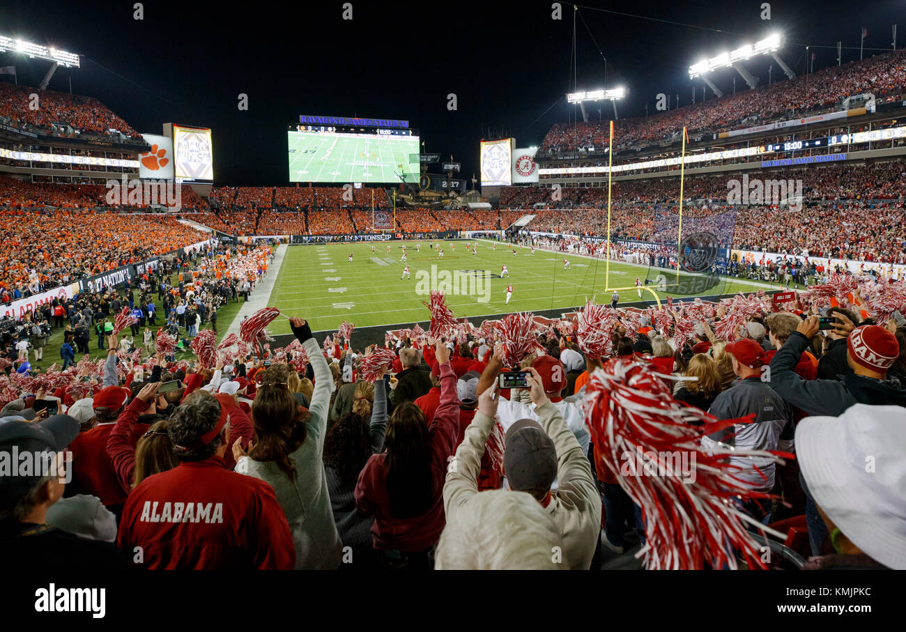 Alabama Crimson Tide and Clemson Tigers fans cheer on their teams at kickoff of the 2017 College Football Playoff National Championship in Tampa, Fla. Stock Photo