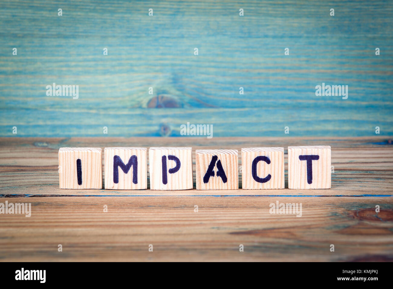 impact - name from wooden letters. Office desk, informative and communication background Stock Photo