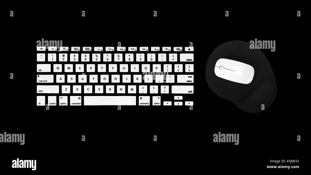 White computer keyboard, mouse and mousepad on a black background Stock Photo