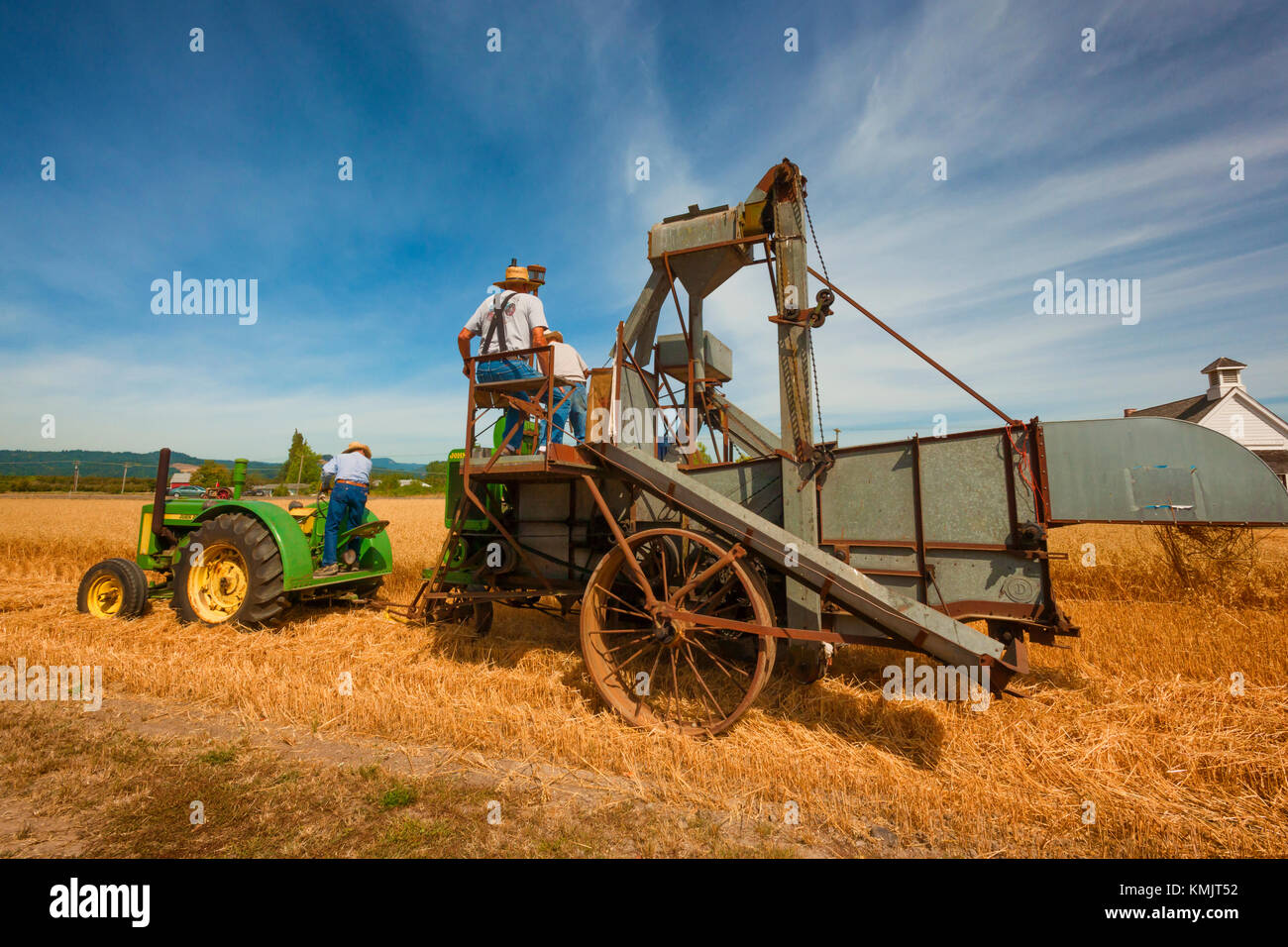 McMinnville, Oregon, USA - Autust 13, 2016:  Senior farmers demostrate how an old grain harverster works at Yamhill County Harvest Festival Stock Photo