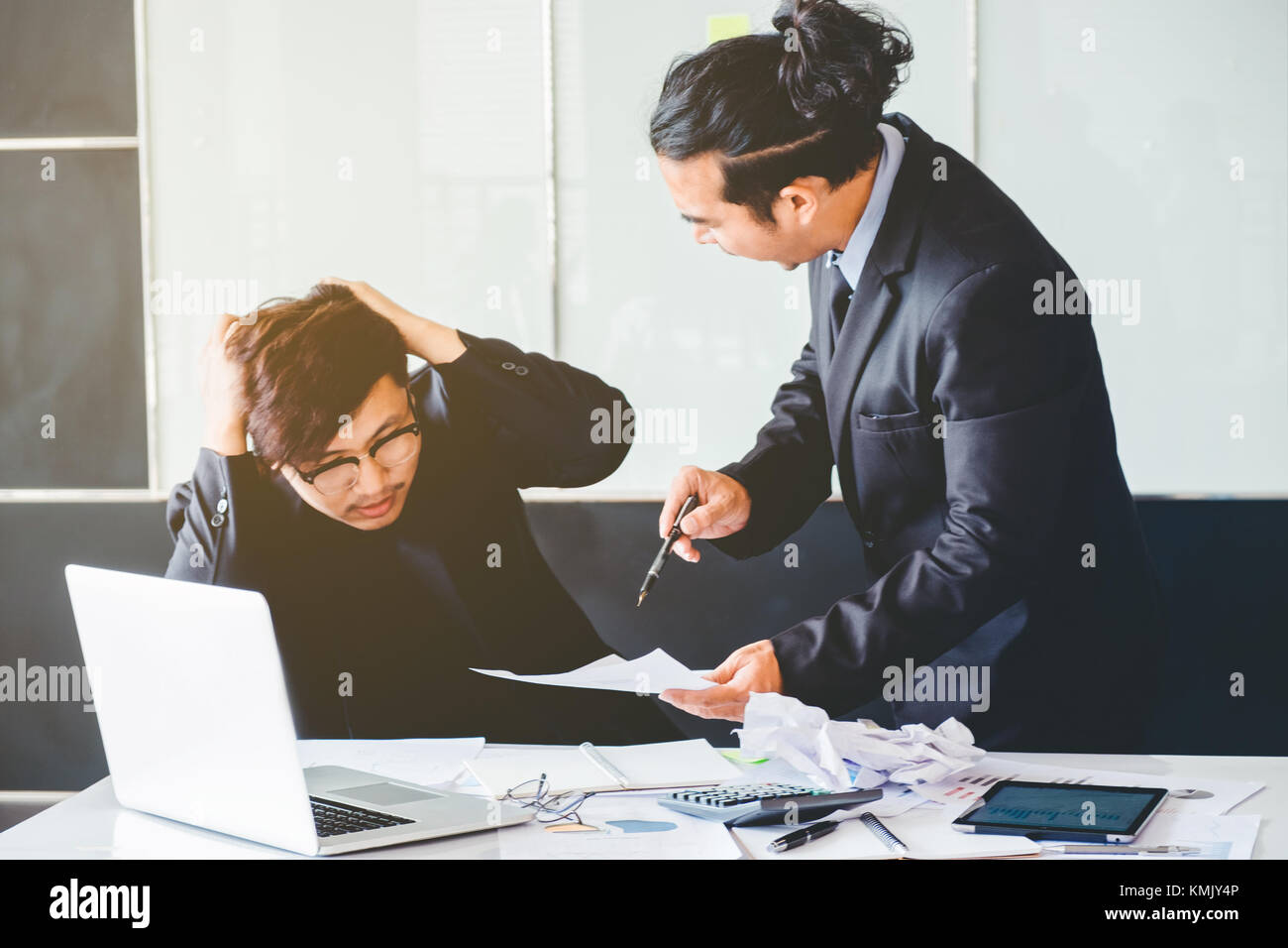 Asian Bad angry boss yelling at business man sad depressed employee reprimand from team leader missed deadline concept Stock Photo