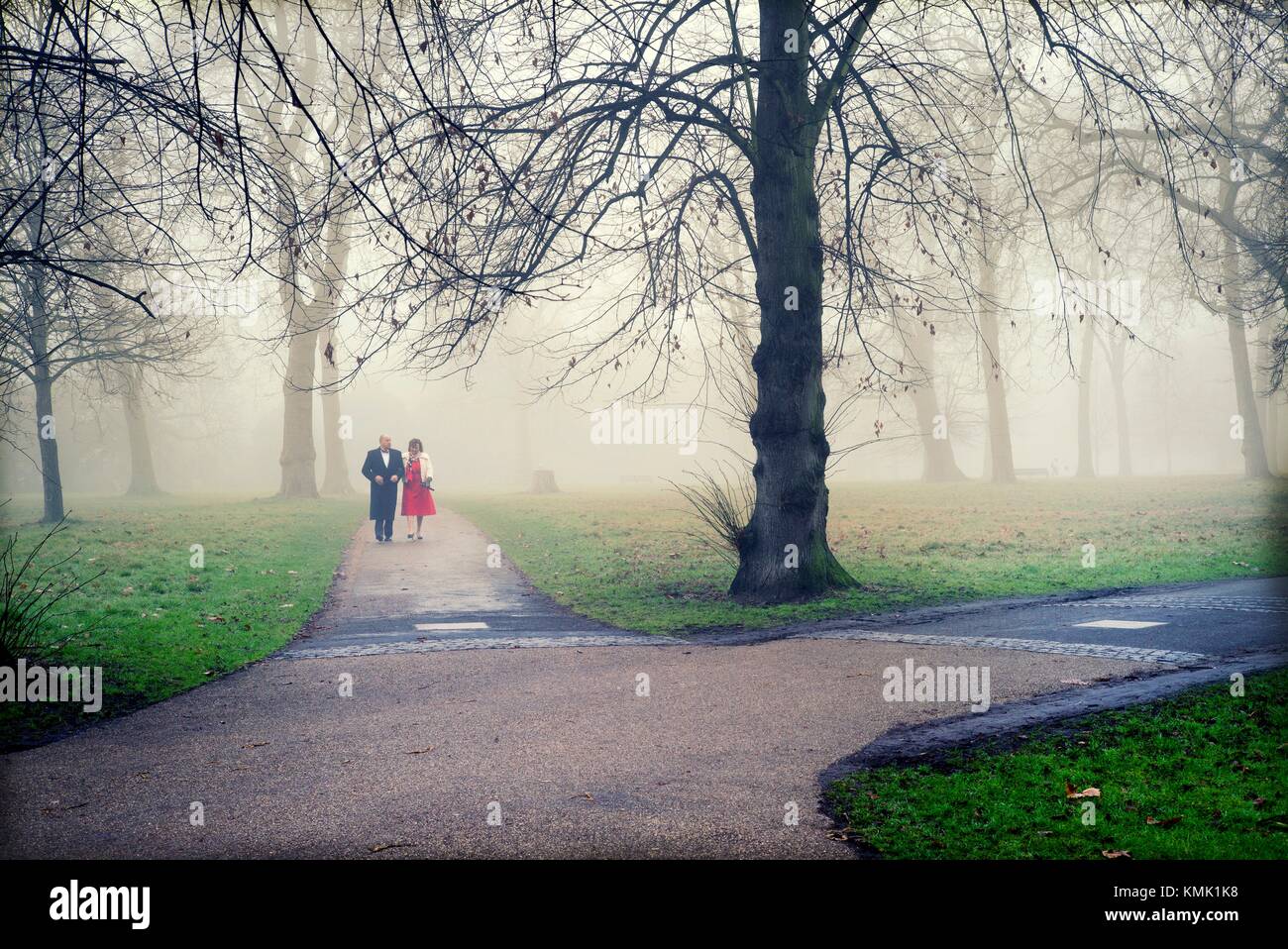 A couple, dressed smartly, walking in Kensington Park Gardens. City of Westminster and Kensington, Chelsea, London, England Stock Photo