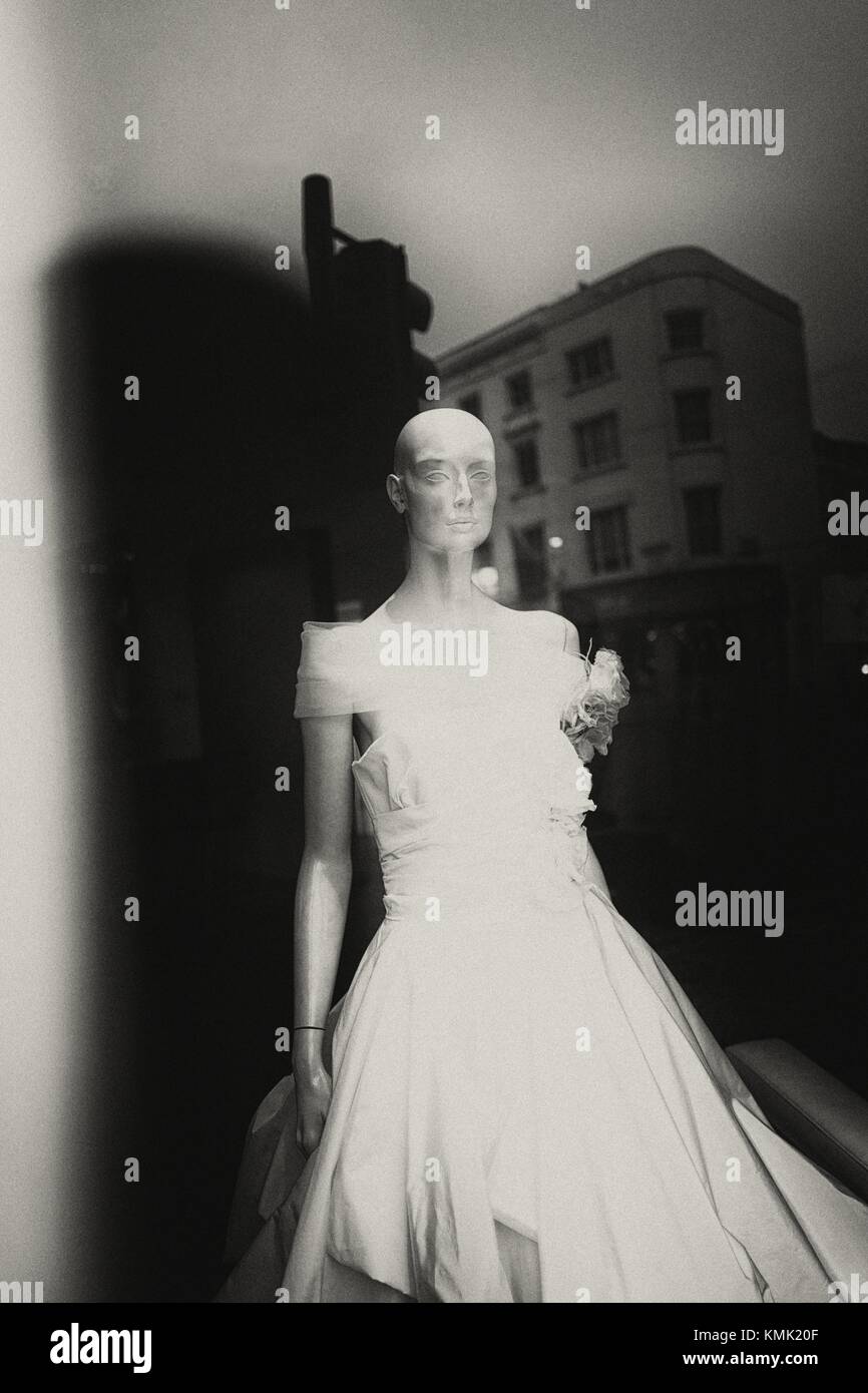 Shop window with mannequin in wedding dress. Reflection of building in glass. London, England Stock Photo