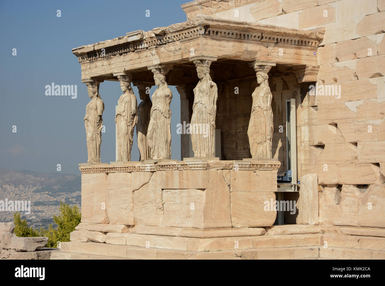 Landscape orientation view of the Erechtheion, Porch of the Maidens/Caryatids, 6 females, at the Acropolis in Athens, Greece on a sunny warm day Stock Photo