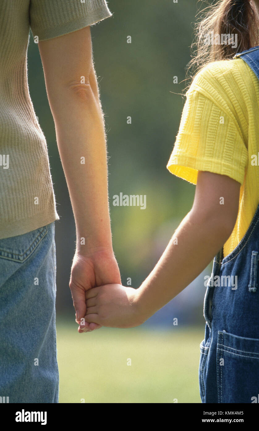 Mother and child hold hands Stock Photo - Alamy