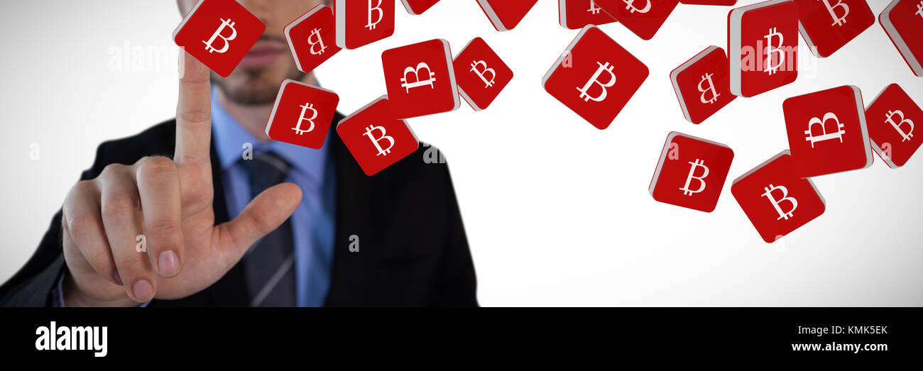 Mid section of mid adult businessman touching on invisible interface against bitcoin symbol Stock Photo