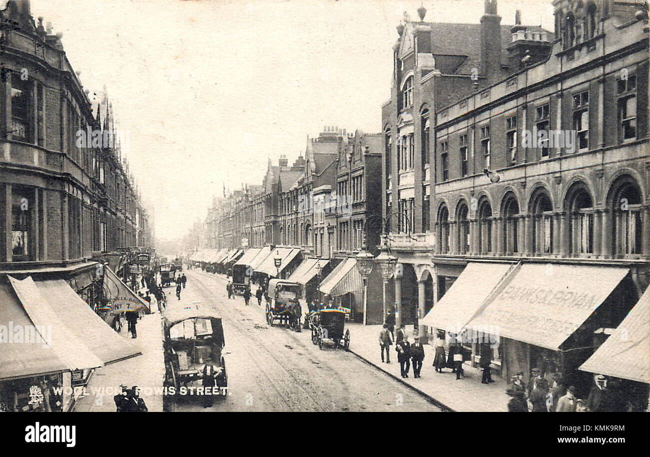 The image depicts Powis Street in Woolwich around 1900. Known for its commercial and residential buildings, the street was an important location in the development of Woolwich during the early 20th century. Stock Photo