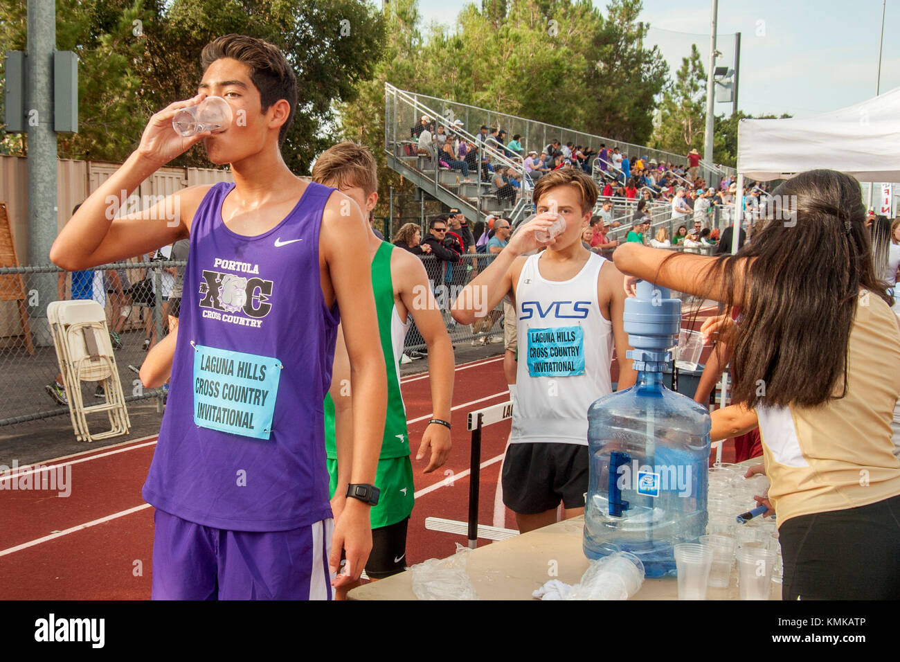 Multiracial teenage boys refresh themselves with fresh water after