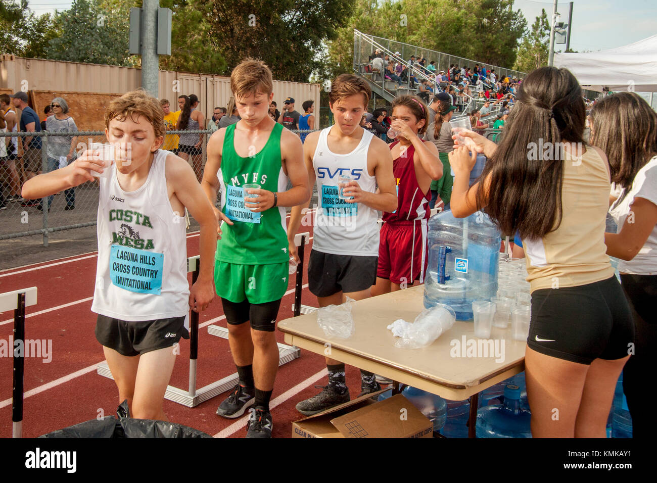 Multiracial teenage boys refresh themselves with fresh water after