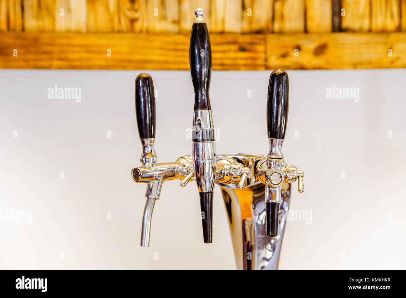 Close up of multiple beer taps located over a wooden table in a blurred background Stock Photo