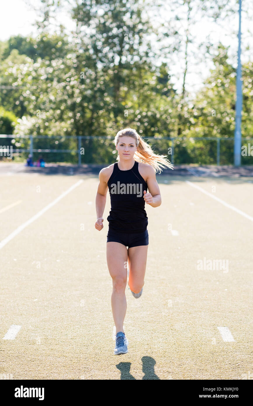 Young Female Athlete Working Out on Track Stock Photo