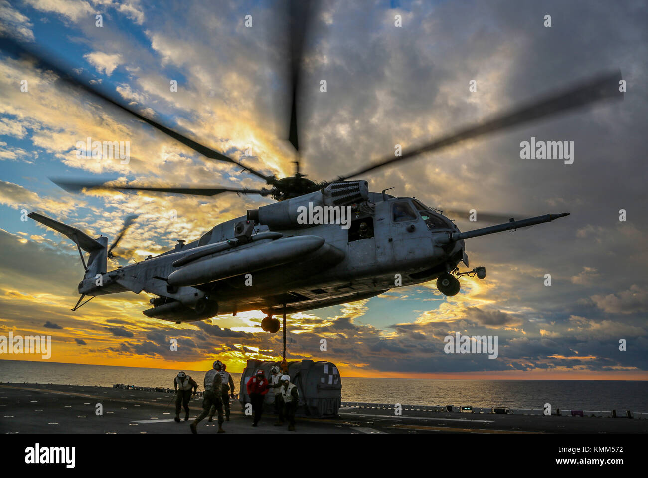 A U.S. Marine Corps CH-53E Super Stallion helicopter picks up an engine from the flight deck aboard the U.S. Navy Wasp-class amphibious assault ship USS Iwo Jima December 1, 2017 in the Atlantic Ocean.  (photo by Jon Sosner via Planetpix) Stock Photo