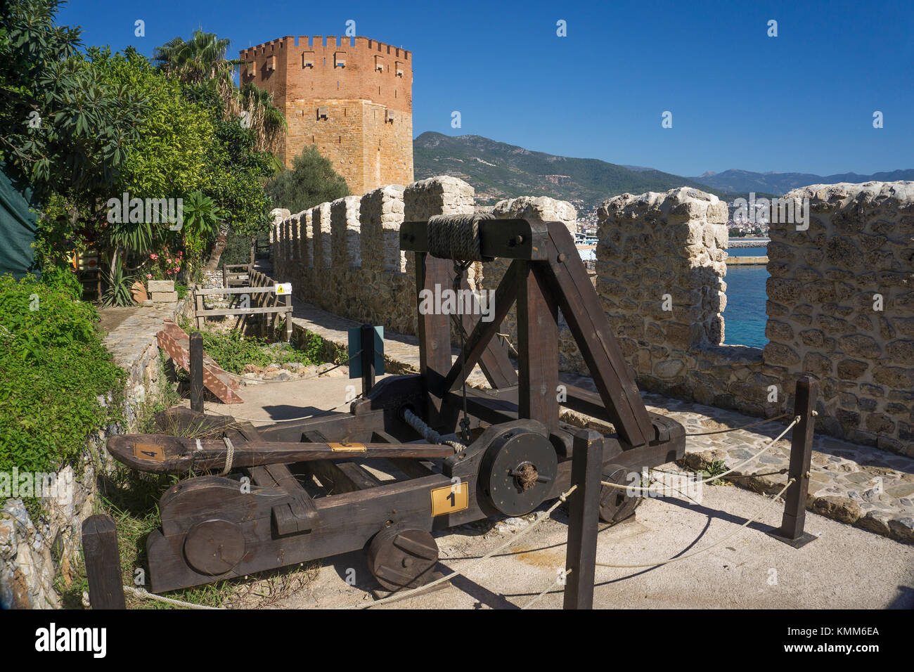Medieval catapult at battlement, close to red tower landmark of Alanya,  turkish riviera, Turkey Stock Photo