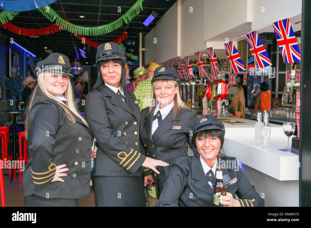 Benidorm new town British fancy dress day group of women dressed as airline pilots Stock Photo