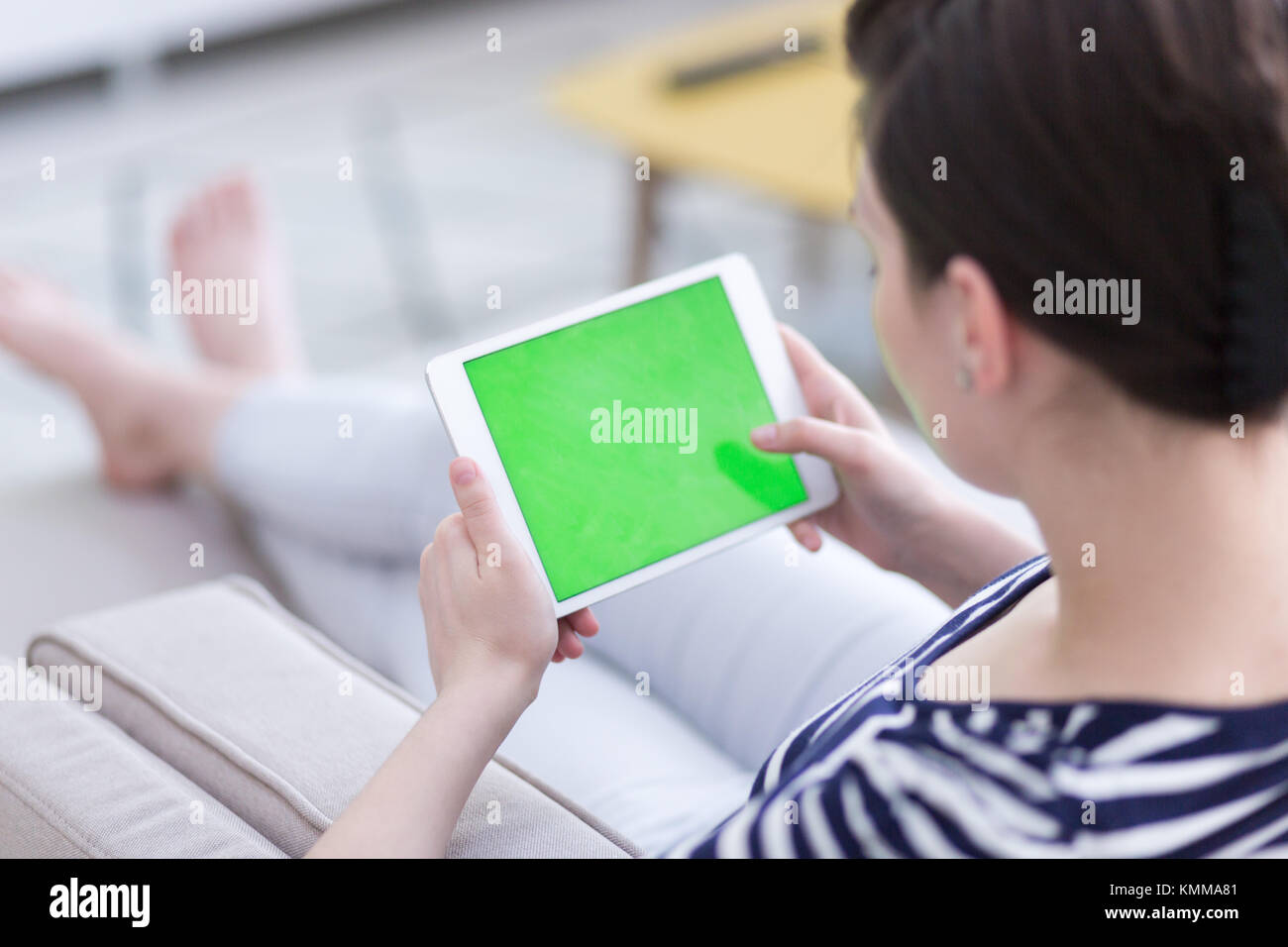 young happy woman on sofa using tablet computer at luxury home Stock ...