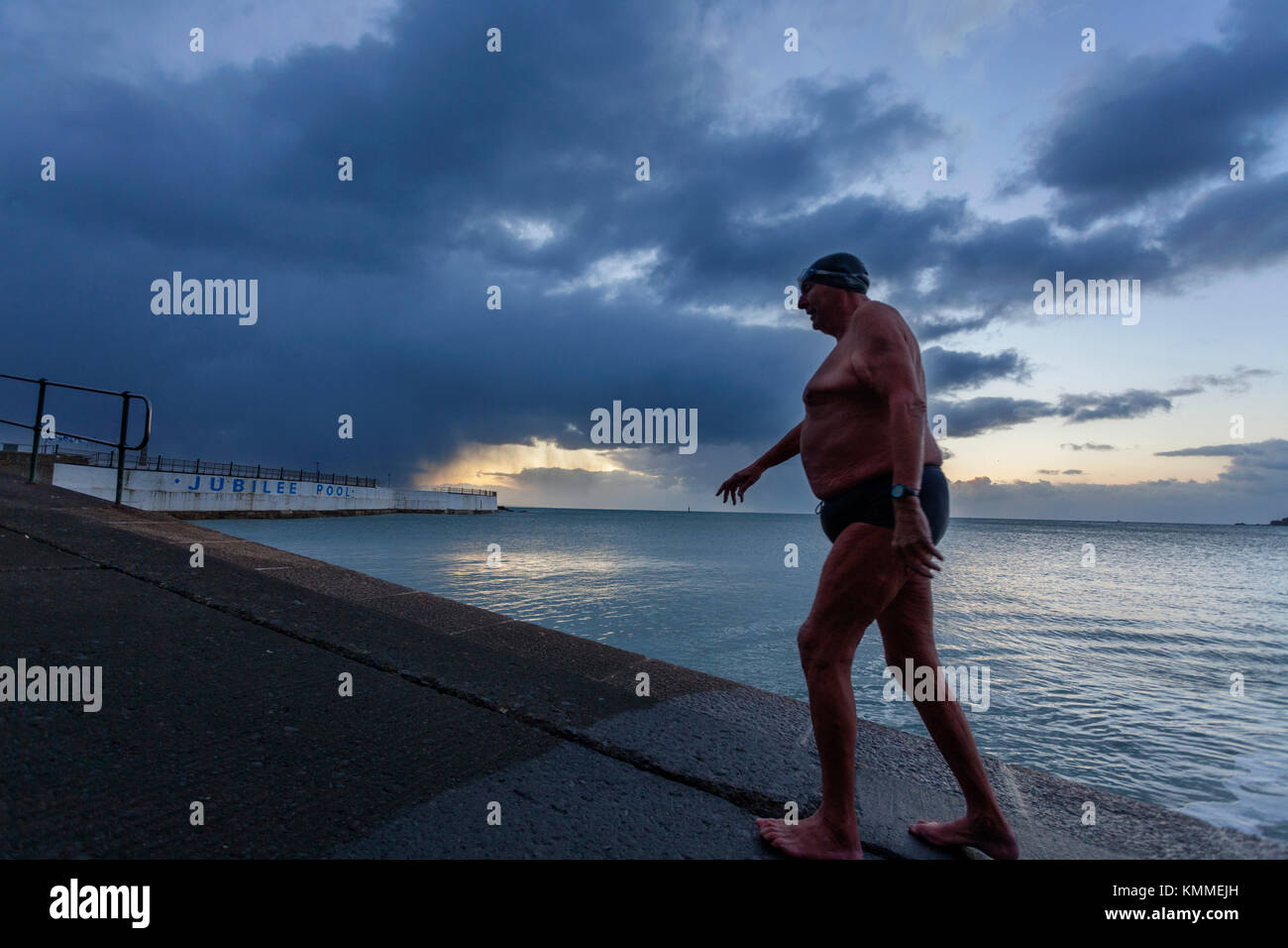 Penzance, Cornwall, UK, 8th December 2017. Early morning, and open water swimmer Bob Anderson exits the sea on one of the coldest UK days of the year. Stock Photo