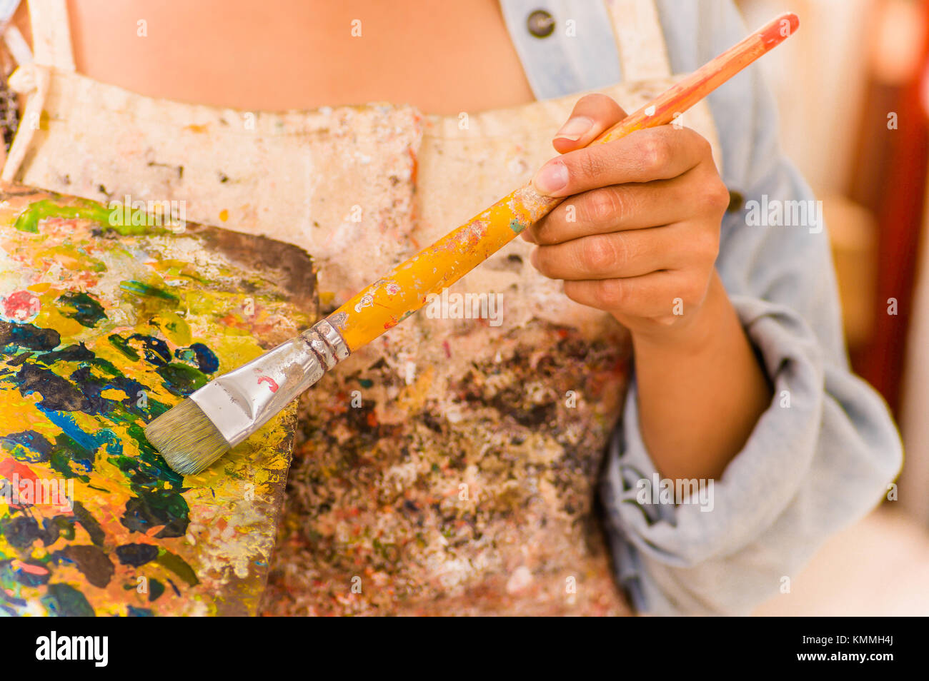 Beautiful young woman painter with color palette and paint brush in ...