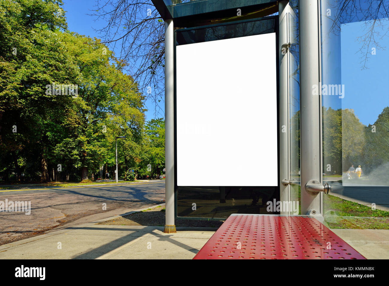 Bus stop advertising. Blank billboard on bus shelter, poster size, vertical Stock Photo