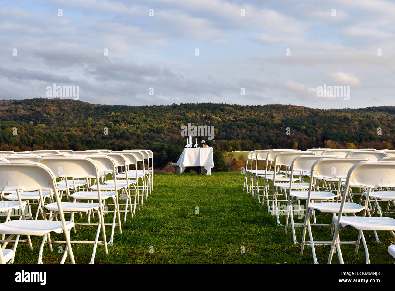 Outdoor wedding reception, service arrangements, chairs, table, bread and wine for a simple ceremony with a beautiful view Stock Photo