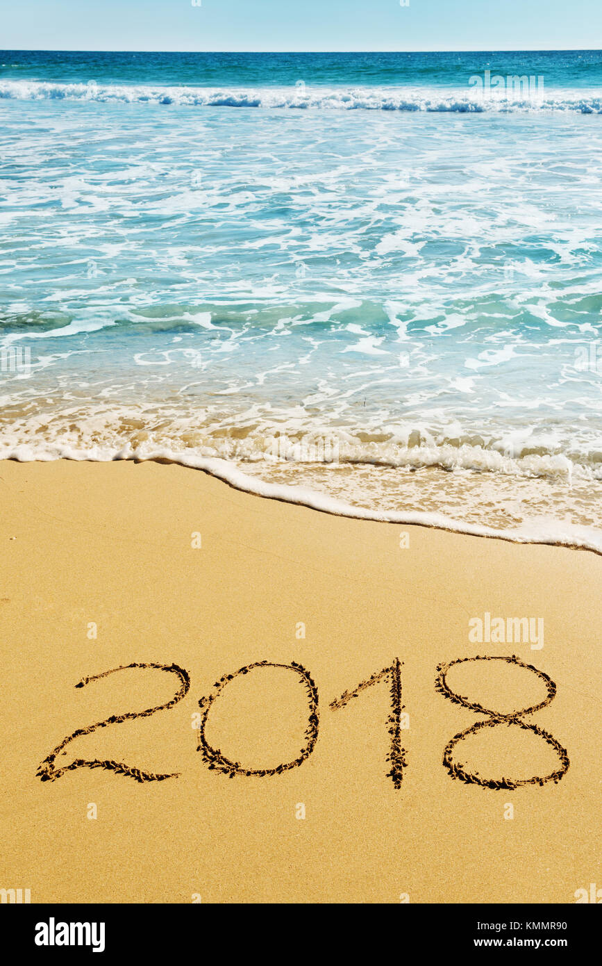 digits  2018 on the sand seashore - concept of New Year and  Xmas Stock Photo