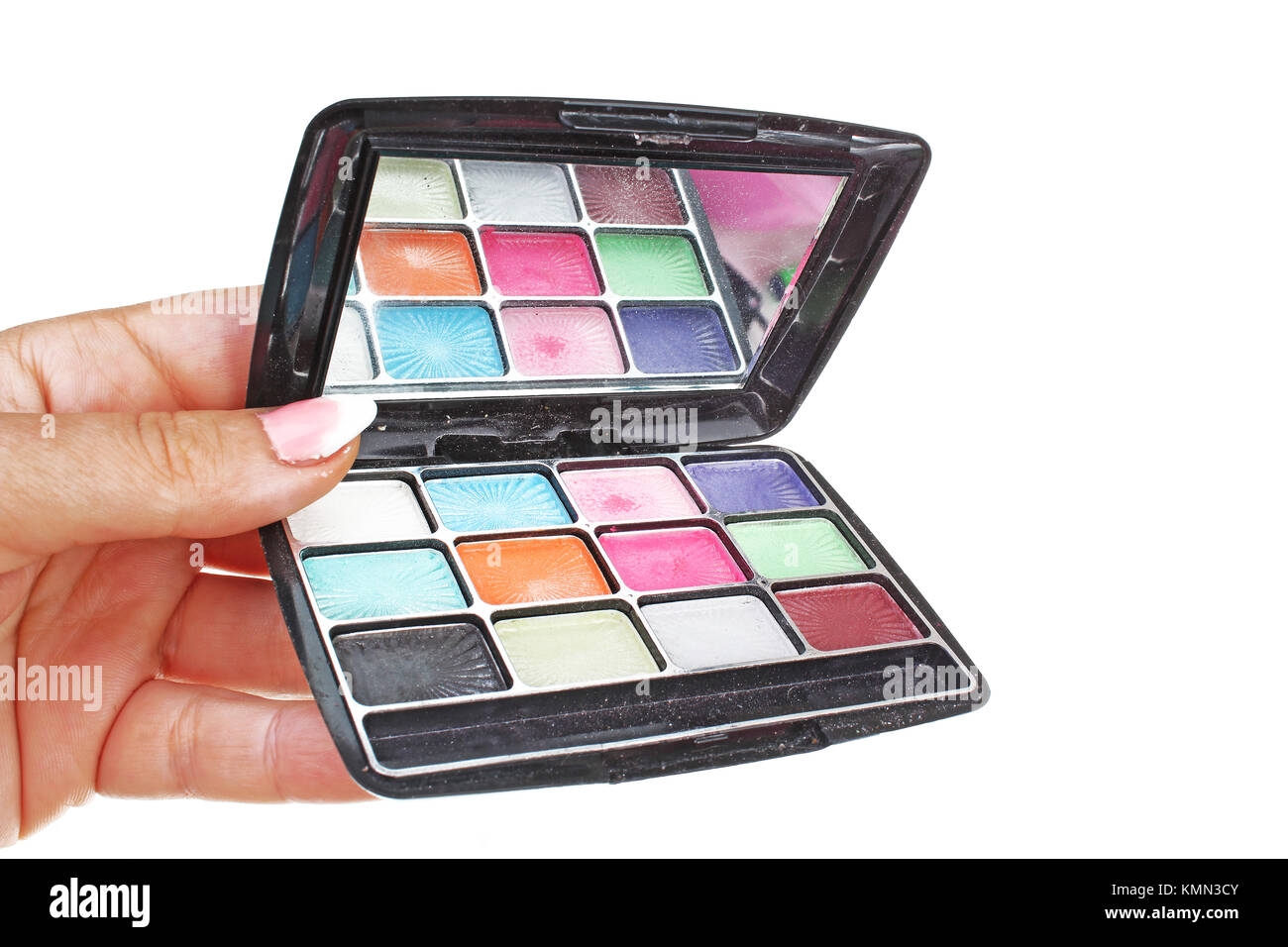 Woman hand holding cosmetic eyeshadow makeup palette on isolated white