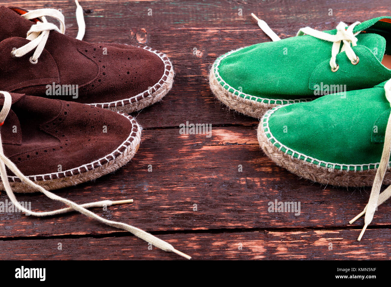 Green and brown suede espadrille shoes on wooden background Stock Photo ...
