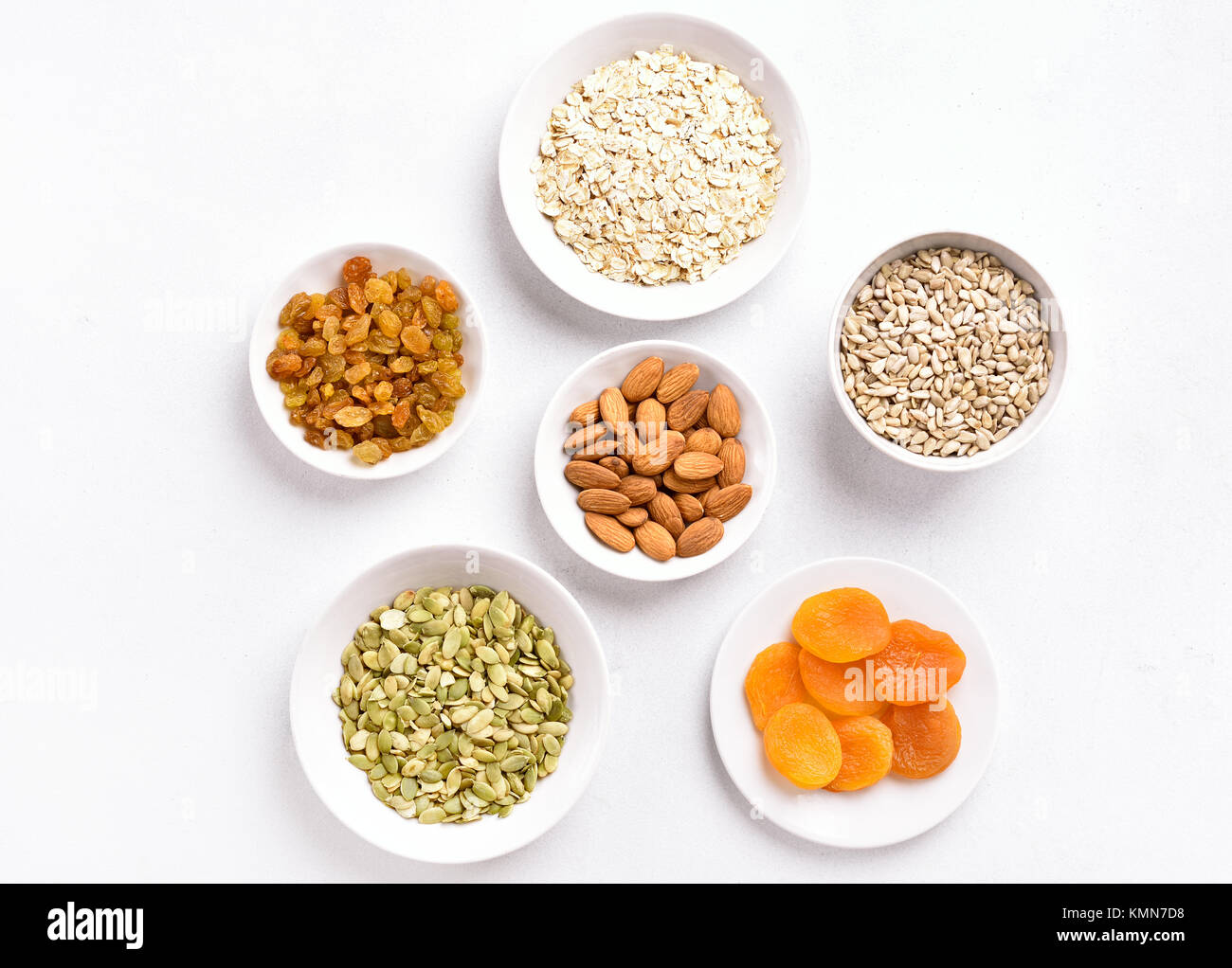 Bowl with ingredients for cooking granola on white background. Top view, flat lay Stock Photo