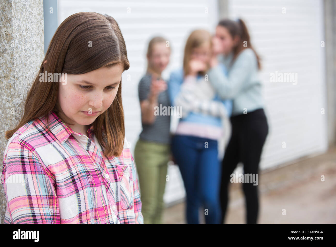 Sad Pre Teen Girl Feeling Left Out By Friends Stock Photo