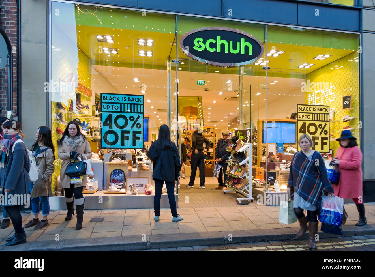 Black Friday sale signs sign on Schuh shoe shop store window England UK United Kingdom GB Great Britain Stock Photo