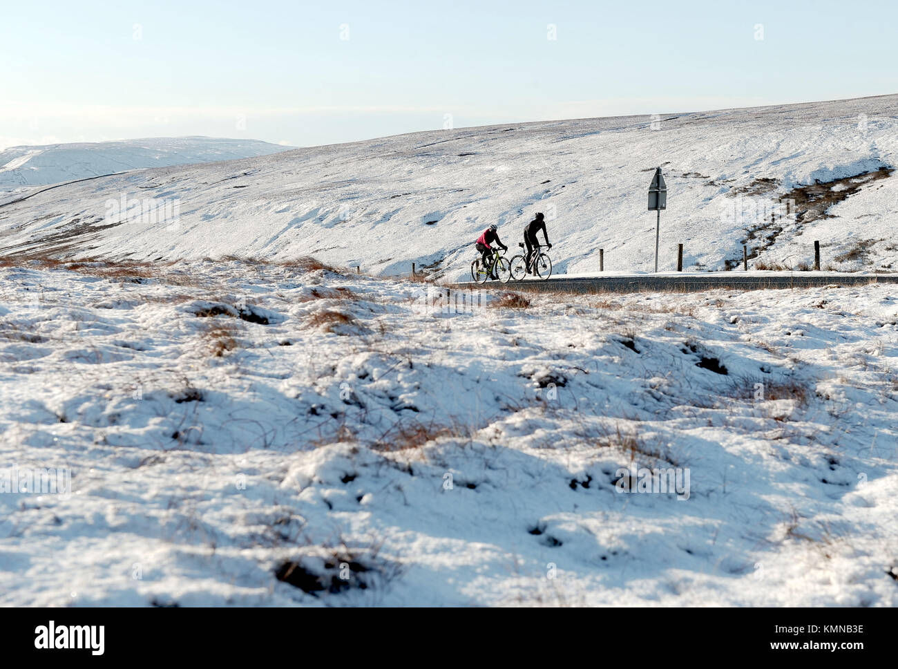 Cyclists climb the Buttertubs pass between Wensleydale and Swaledale as parts of the UK and Ireland woke up to a blanket of snow caused by an Arctic airflow in the wake of Storm Caroline. Stock Photo