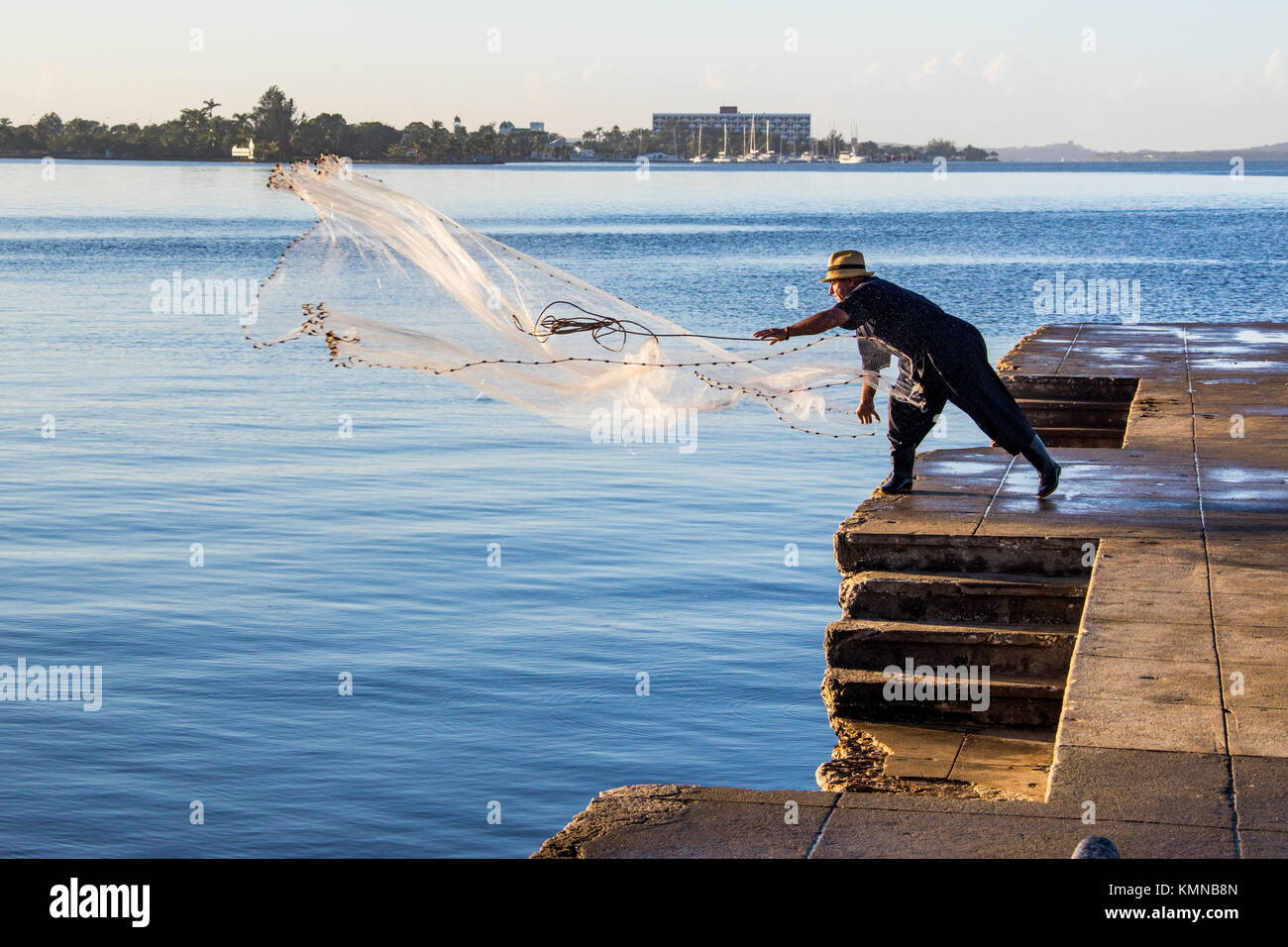 Image of Fisherman Throwing Fishing Net In to River-HU390644-Picxy