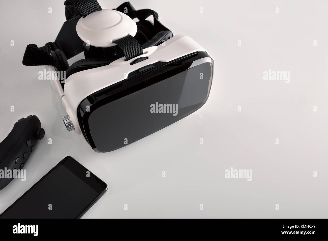 Black and white virtual reality glasses with smartphone on white ...