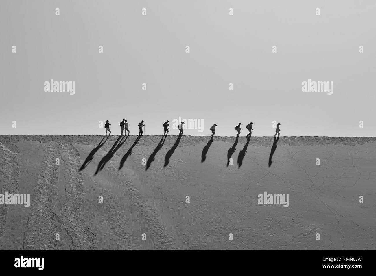 Tourists climbing a dune in the Namibian desert at Dead Vlei Stock ...