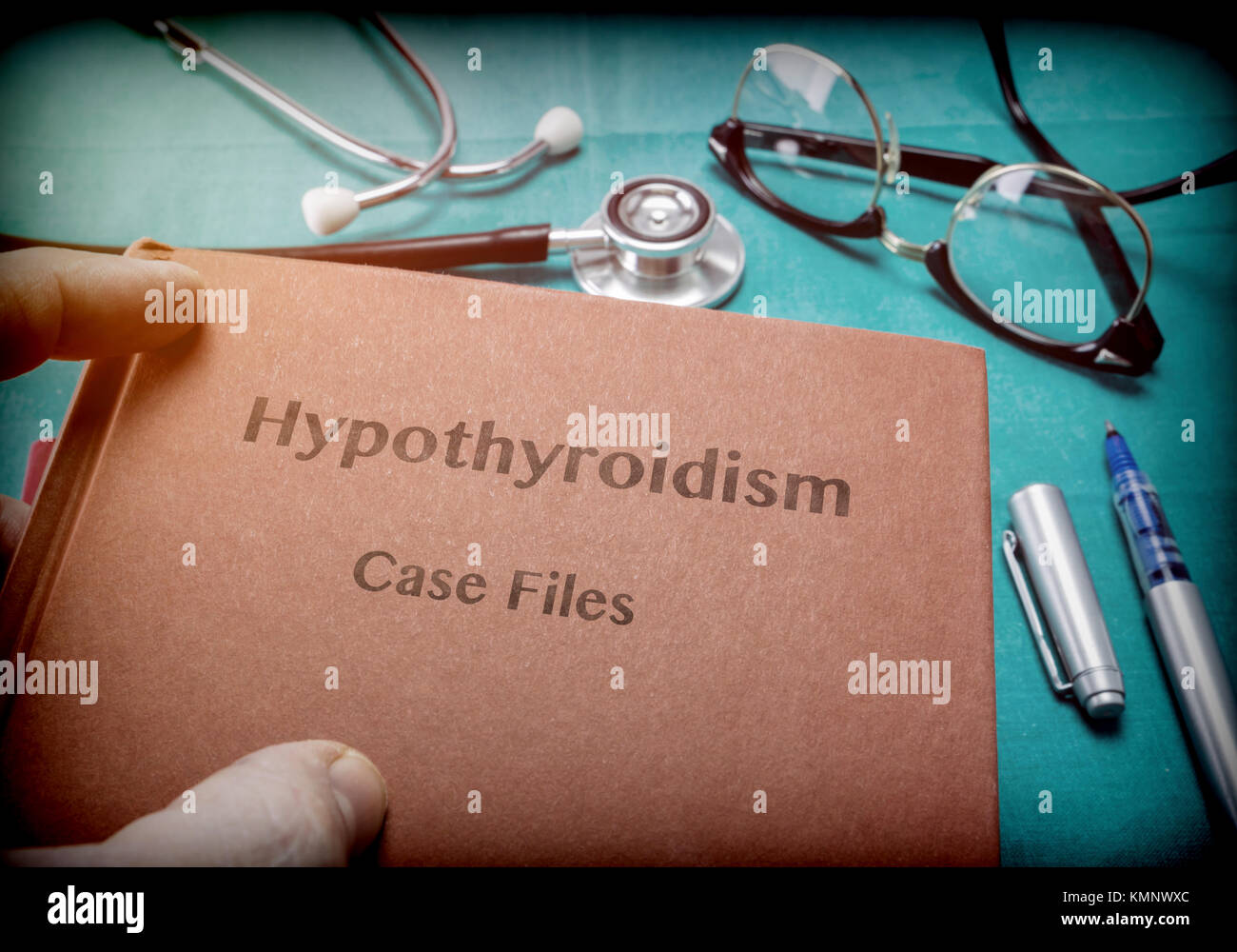 Doctor holds in its hands a book on the Hypothyroidism, conceptual image Stock Photo