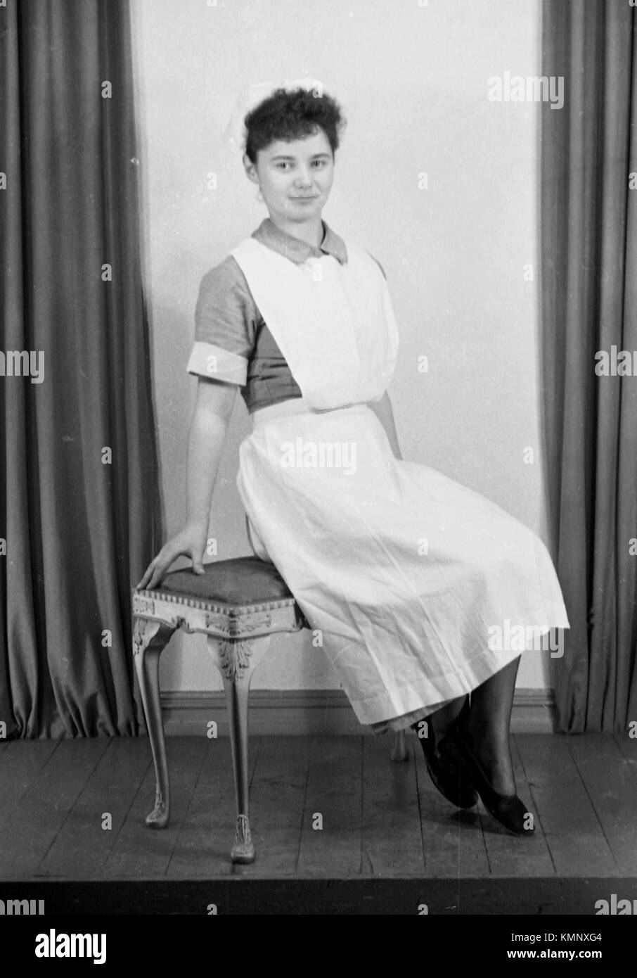 A nurse poses in typical uniform of the time c1950. Photograph by Tony Henshaw Stock Photo