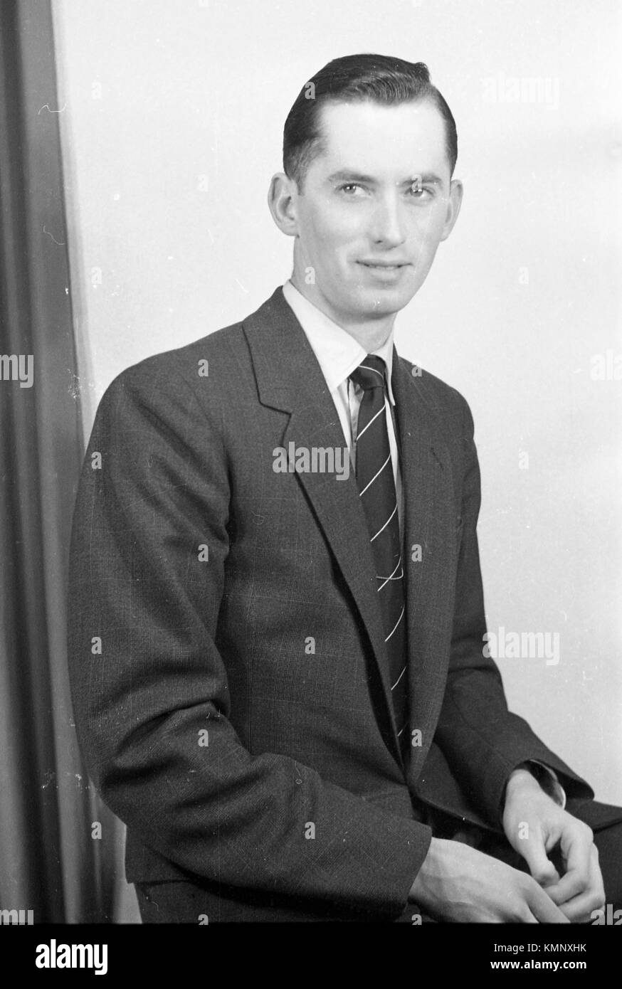 A suited young man in formal pose to camera. c1950.  Picture By Tony Henshaw Stock Photo