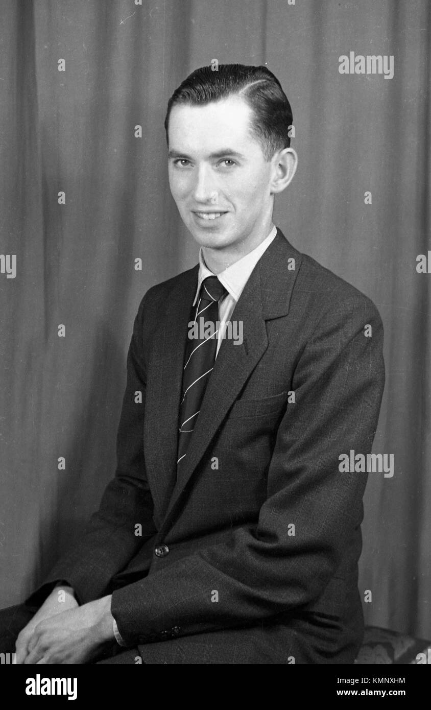 A suited young man in formal pose to camera. c1950.  Photograph by Tony Henshaw Stock Photo