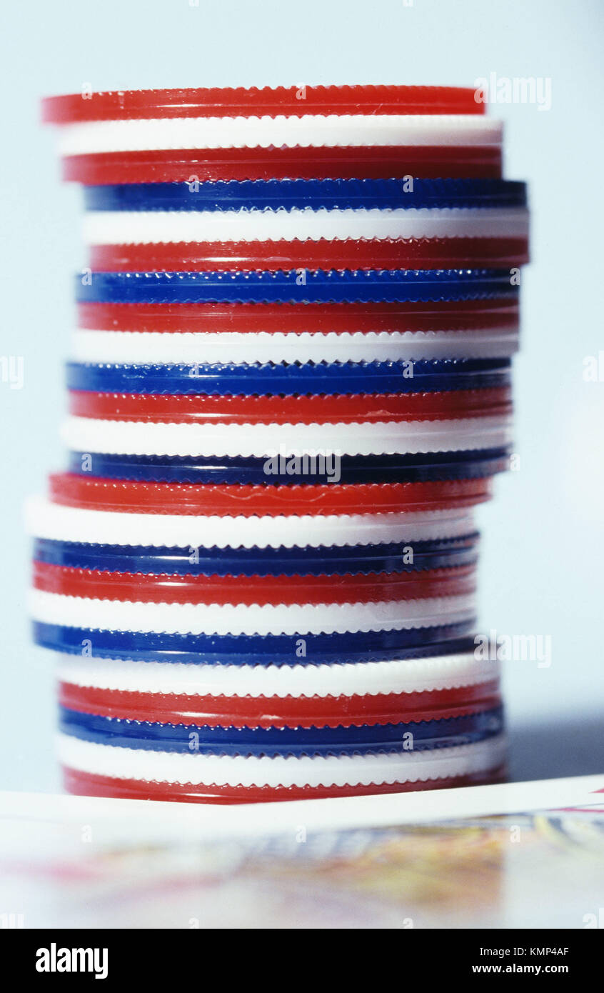 Stacked red, white and blue poker chips and playing card Stock Photo