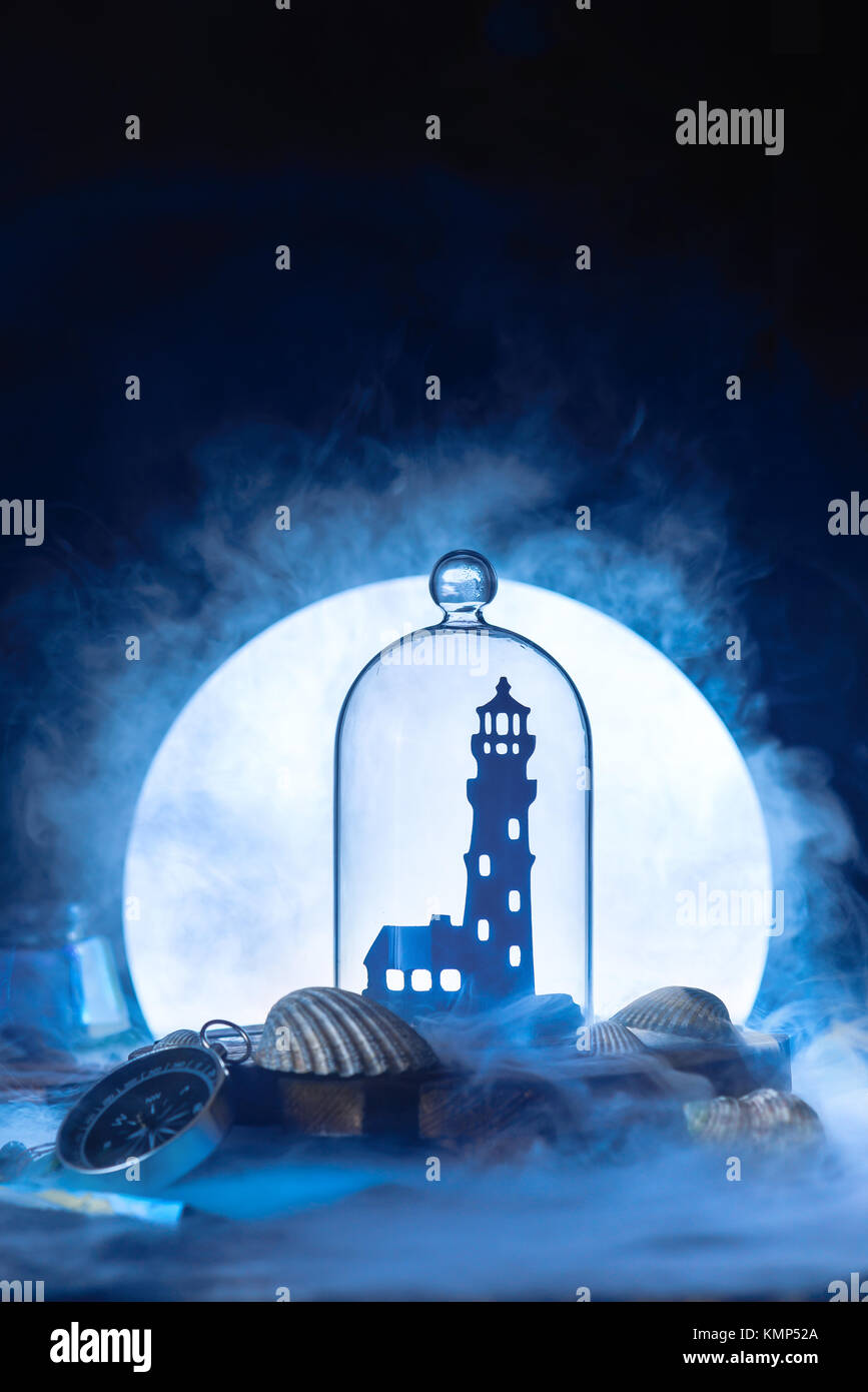 Sea still life with lighthouse silhouette in full Moon. Night ocean scene with smoke on water and copy space. Conceptual paper craft. Stock Photo