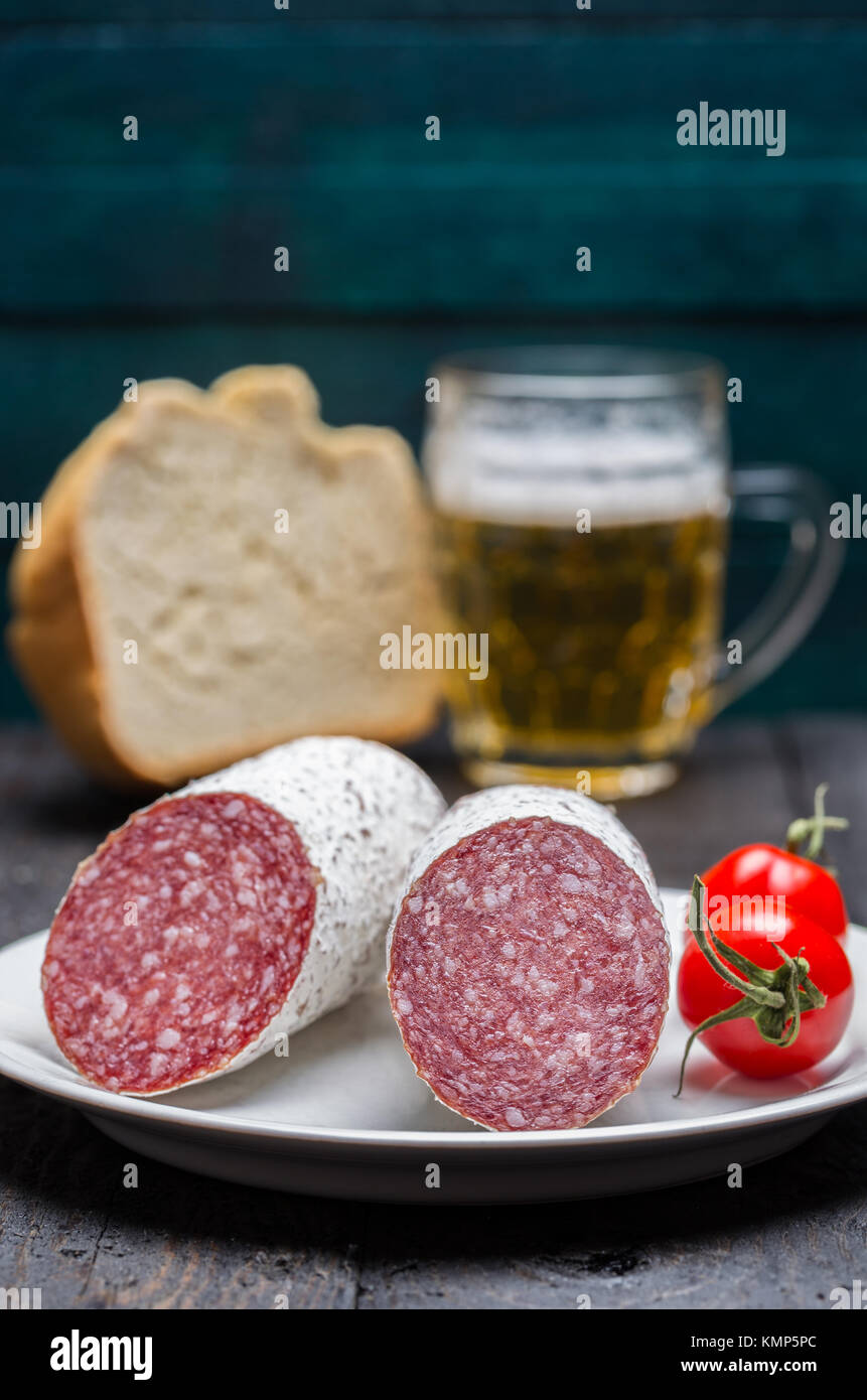 Salami snack on wooden background. Stock Photo