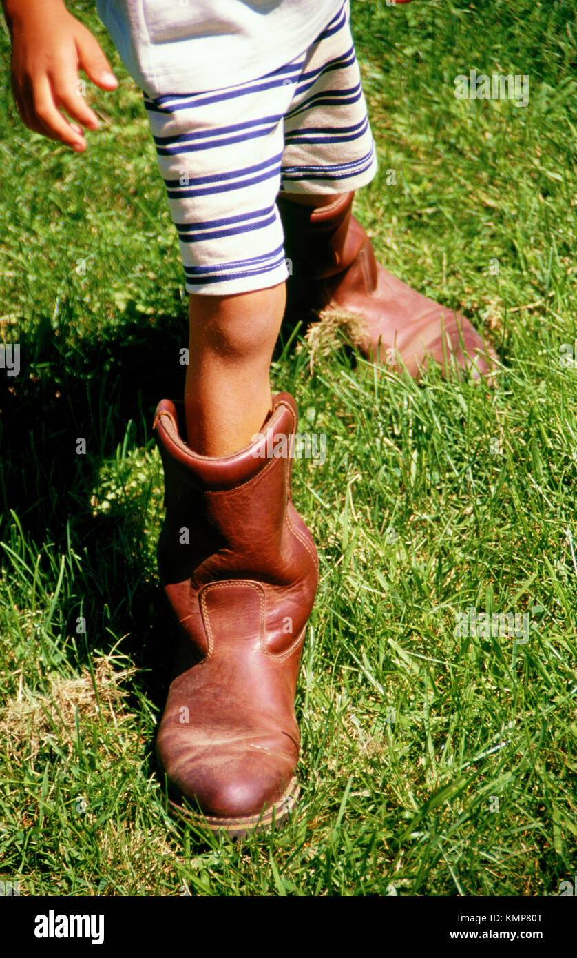 Boy (4 yrs. Old) with oversized boots Stock Photo