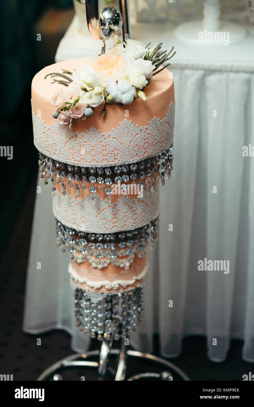 Three Floor Orange Wedding Cake Decorated With White And Beige