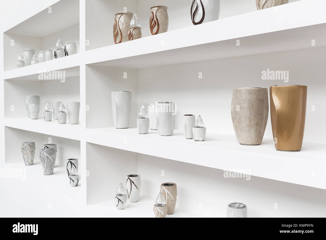 Exhibition of funerary urns, propped on a shelf white Stock Photo Alamy