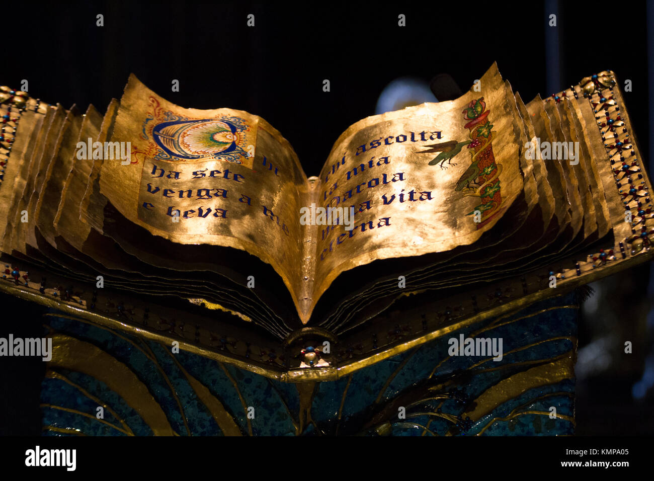A golden book with inscriptions in Latin and designs. Stock Photo