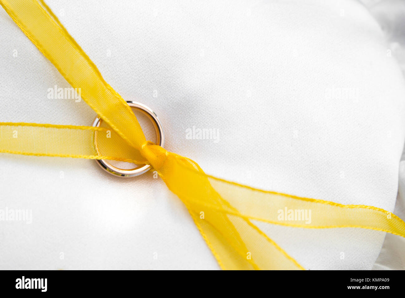 Wedding rings resting on a white pillow. Stock Photo