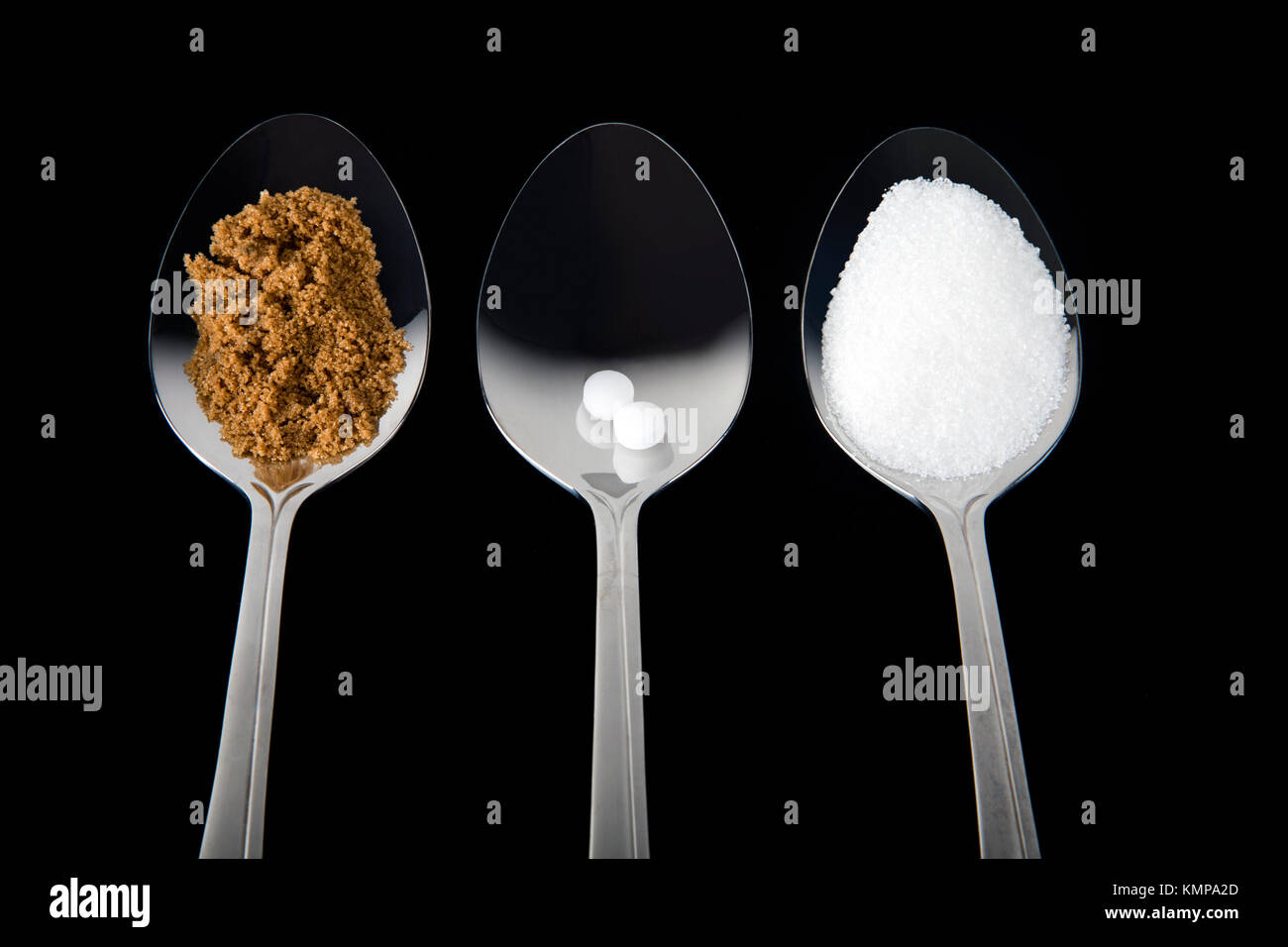 Studio shot of spoons with brown sugar, sweetener and white sugar Stock Photo