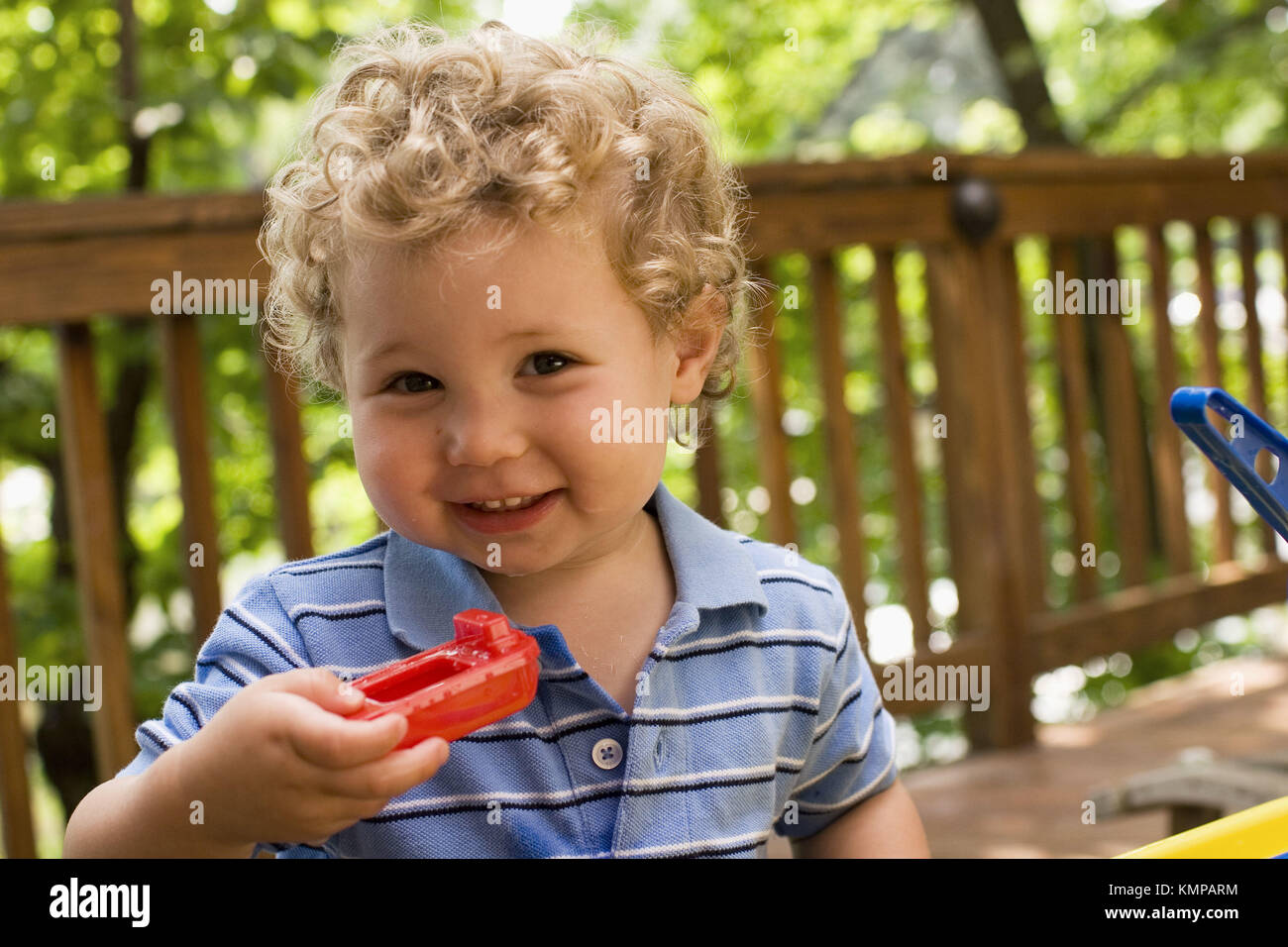 2 year old boy with a toy boat Stock Photo Alamy