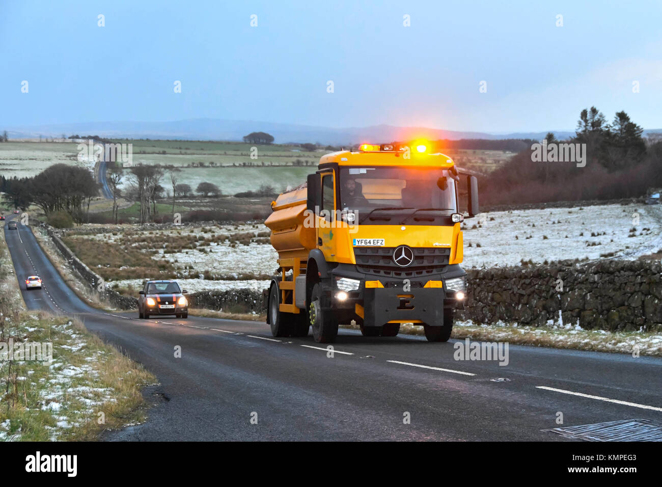 Princetown, Dartmoor, UK.  8th December 2017.  UK Weather.  A Devon County Council gritting lorry on a snow flanked B3357 near Princetown in the Dartmoor National Park in Devon on a cold wintery afternoon spreading grit ahead of a forecast night of ice and snow showers.  Picture Credit: Graham Hunt/Alamy Live News Stock Photo