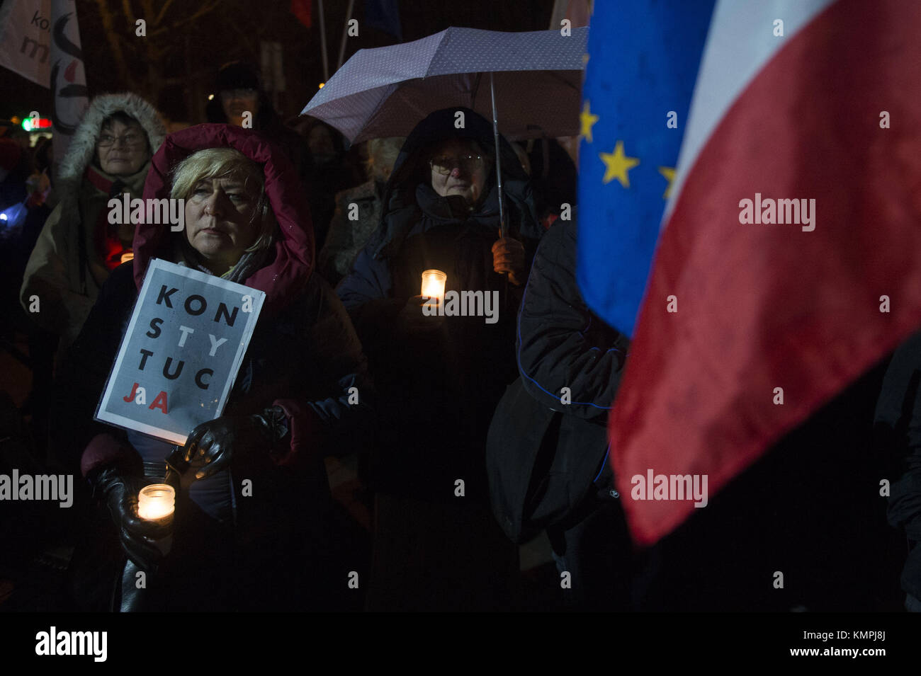 Krakow, Poland. 8th Dec, 2017. Women holds several candles during a protest against the new judicial reforms. Today, The Polish parliament approved the government proposals to hand the ruling Law and Justice party (PiS) total control of judicial appointments and the supreme court.appointments and the supreme court. Credit: Omar Marques/SOPA/ZUMA Wire/Alamy Live News Stock Photo